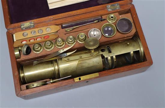 An 18th century brass Culpepper type monocular microscope, together with interchangeable lenses and slides, cased